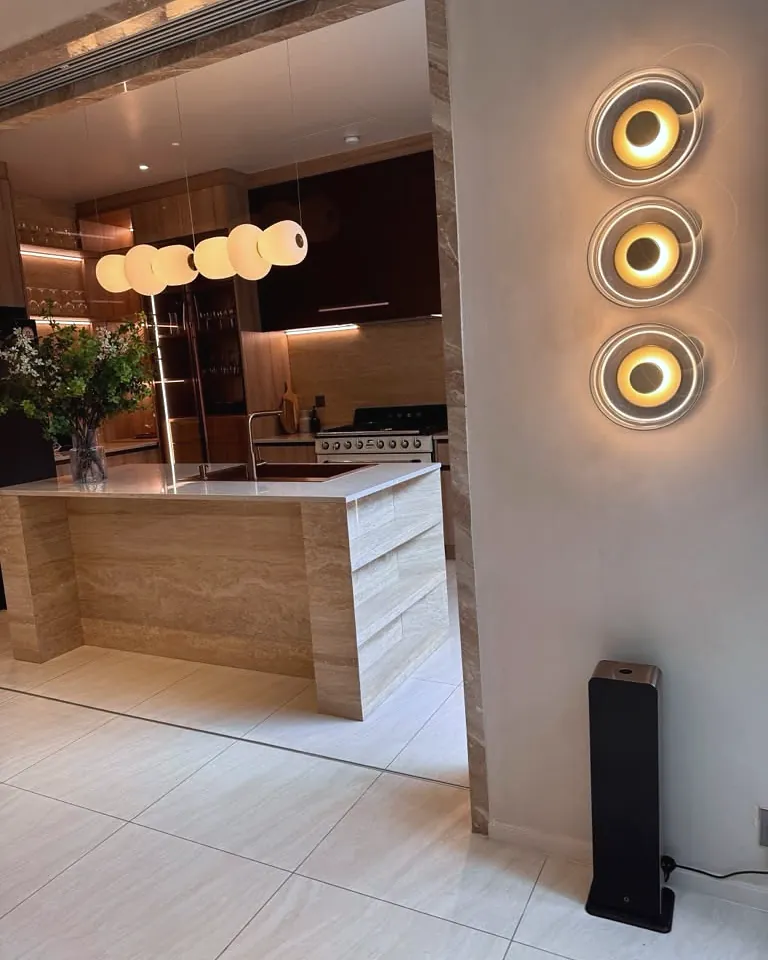 Black tower scent diffuser at the entrance to the kitchen of a private residence